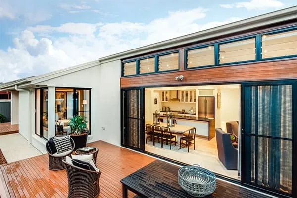 Aluminium patio doors opening a kitchen out to the garden deck