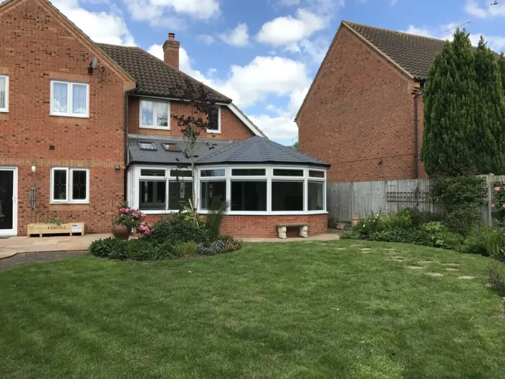 Conservatory with its new tiled roof, seen across the garden