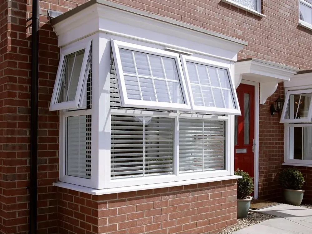 White uPVC casement windows above a brick porch
